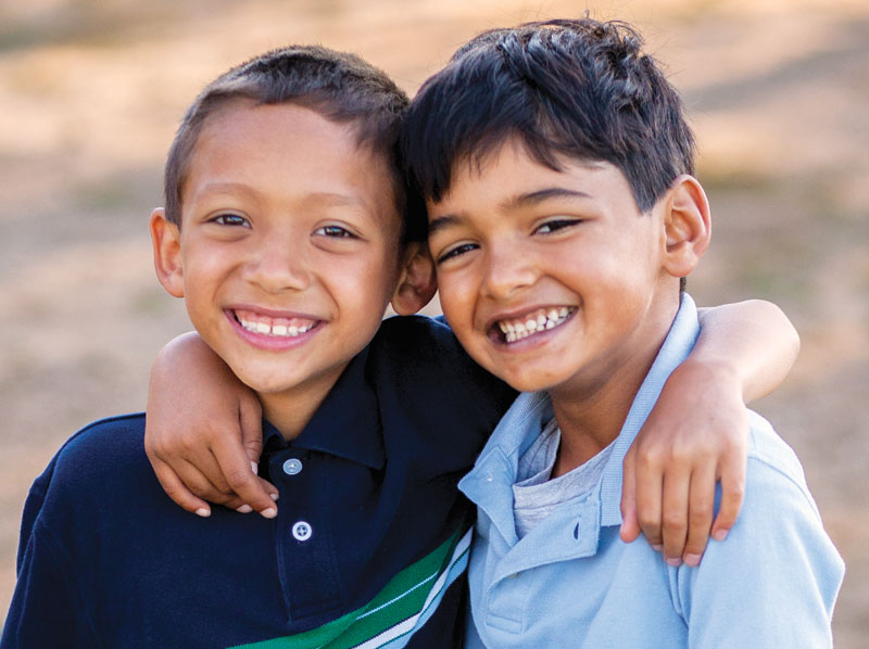 Two young boys smiling.