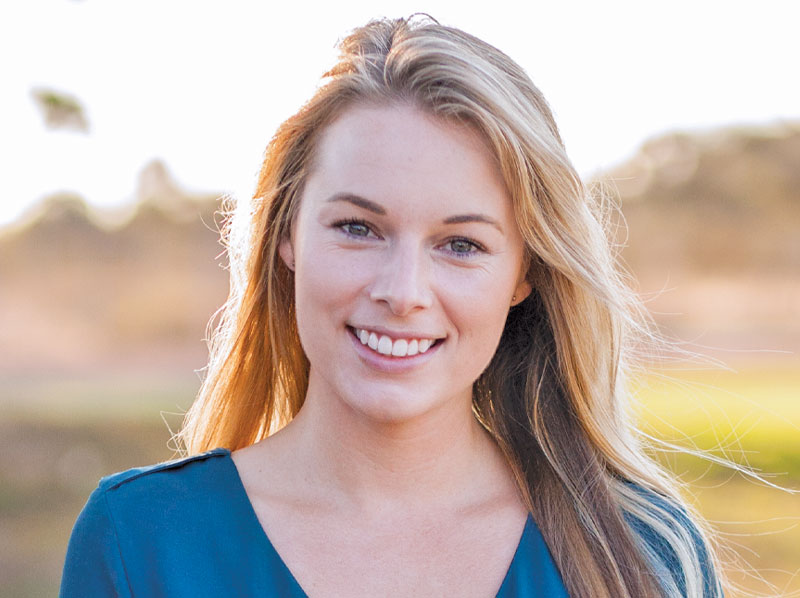 A young lady smiling.